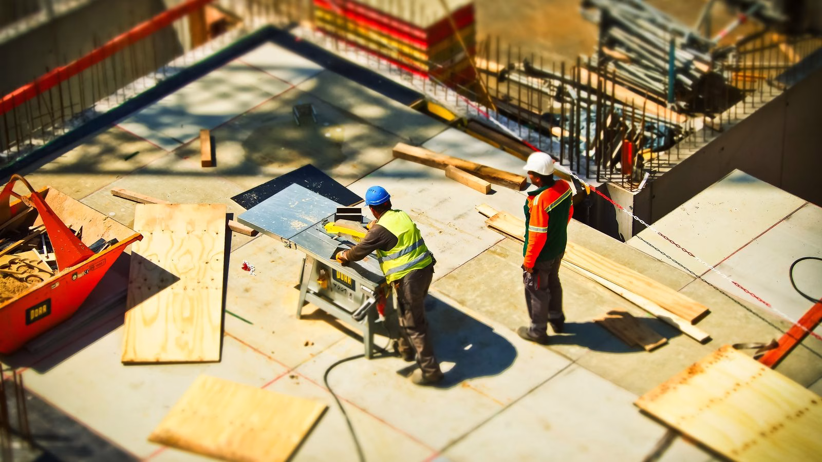 construction workers wearing hard hats at an outdoor building site