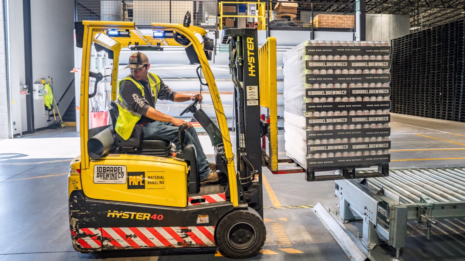 warehouse forklift operator moving pallets in a distribution center